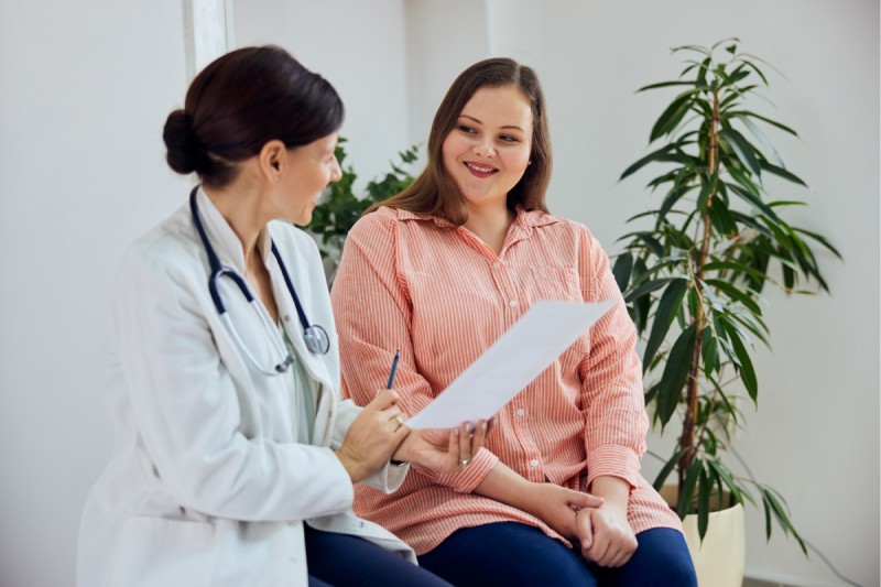 woman happy with bhrt treatment results discussing plan with doctor