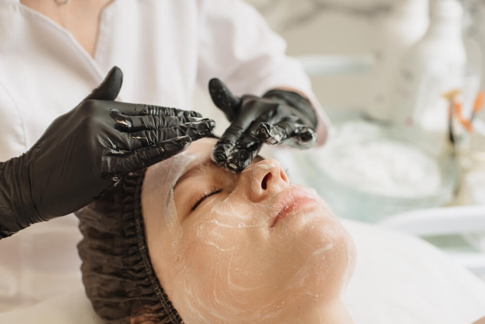 woman taking enzyme peel treatment at spa