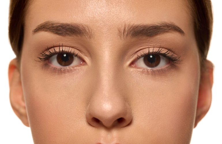 Woman with lifted and curled lashes after a professional lash lift treatment in Tampa at Health & Medspa