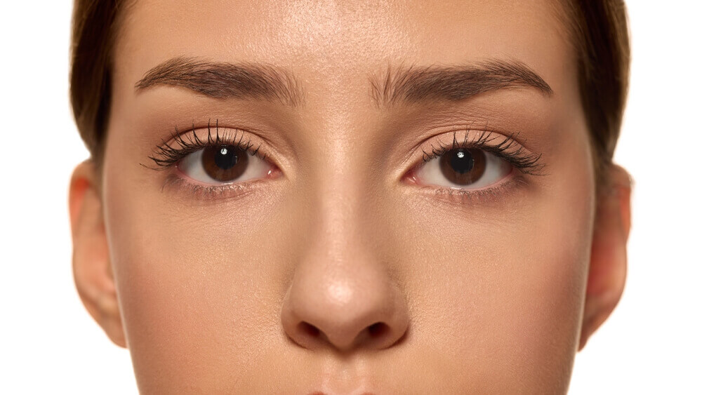 Woman with lifted and curled lashes after a professional lash lift treatment in Tampa at Health & Medspa