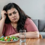 Woman worried because of weight gain and looking for bioidentical hormone replacement therapy for weight loss and hormonal balance treatment