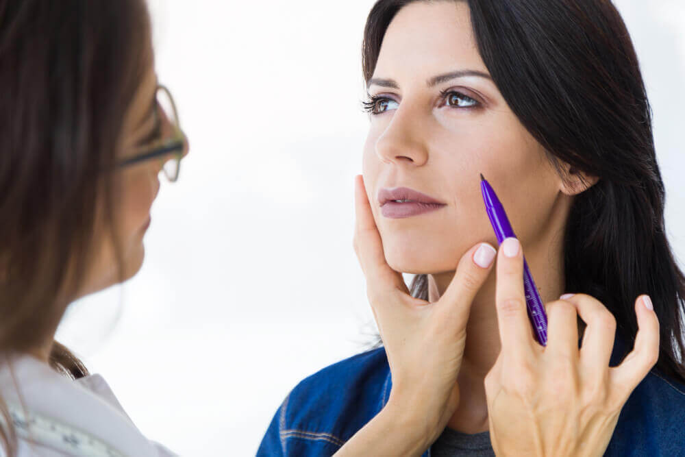 Patient consulting with aesthetic expert for personalized cheek filler treatment plan