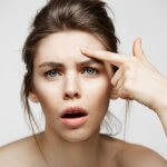 Woman with hooded eyes looking concerned before Botox treatment