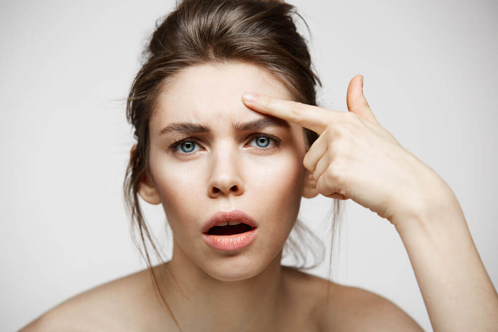 Woman with hooded eyes looking concerned before Botox treatment