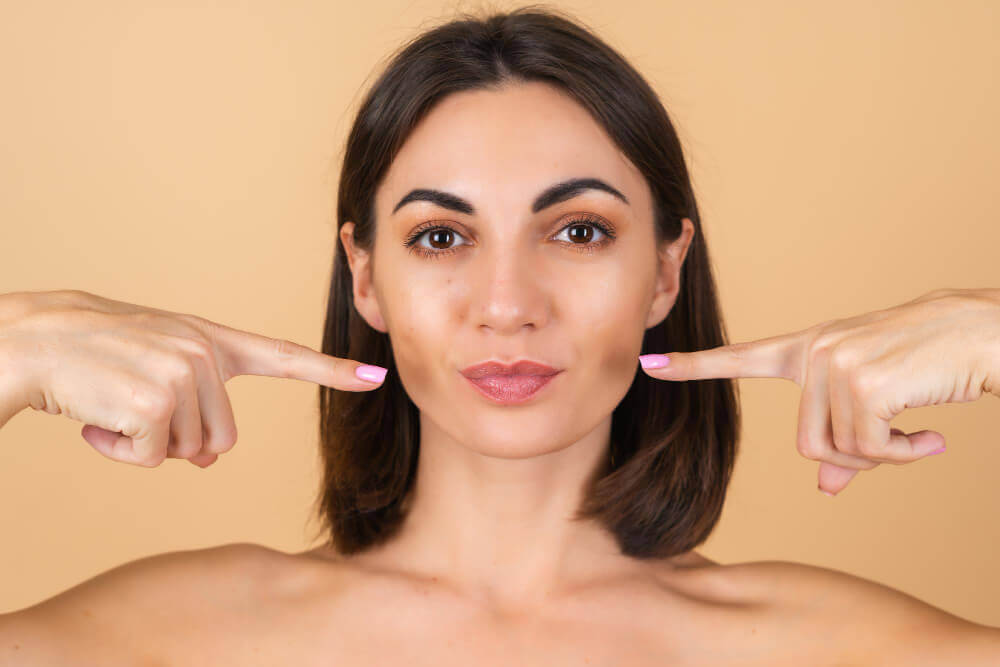 woman  showing volume loss in cheeks and deepening nasolabial folds with aging