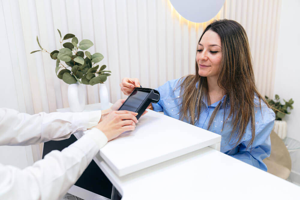 Woman using care credit card for easy medspa patient financing or online payment approval