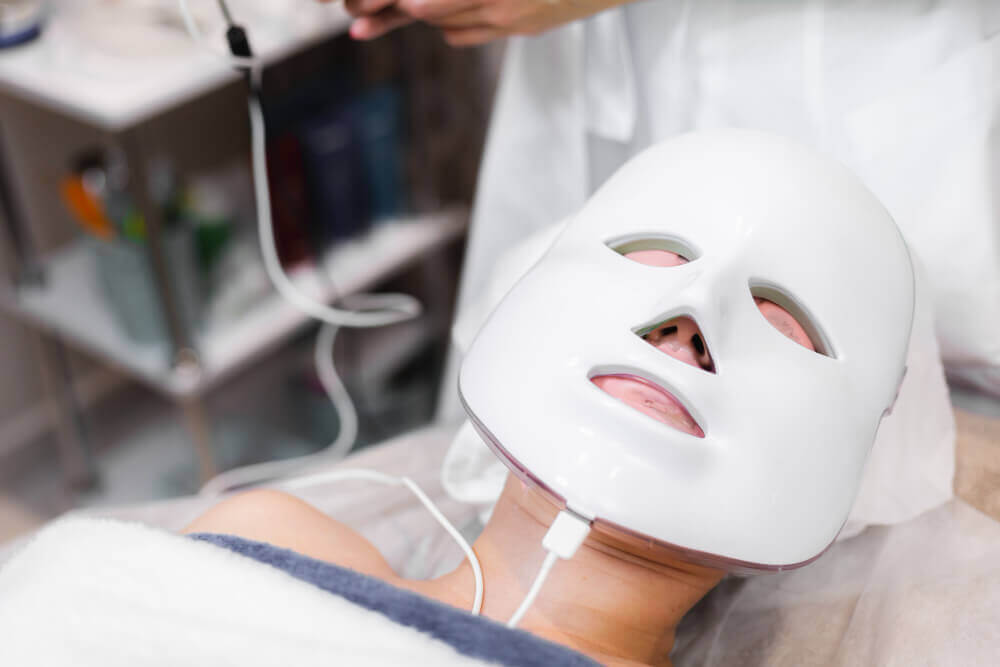 Client undergoing professional LED light therapy treatment in a medspa for skin healing, glow, and overall skin improvement.
