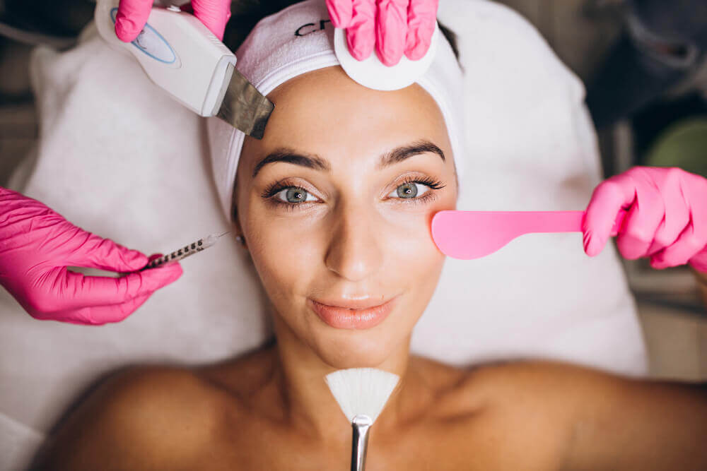 Woman receiving a professional dermaplane facial treatment at Health & Medspa in Tampa for glowing smooth skin