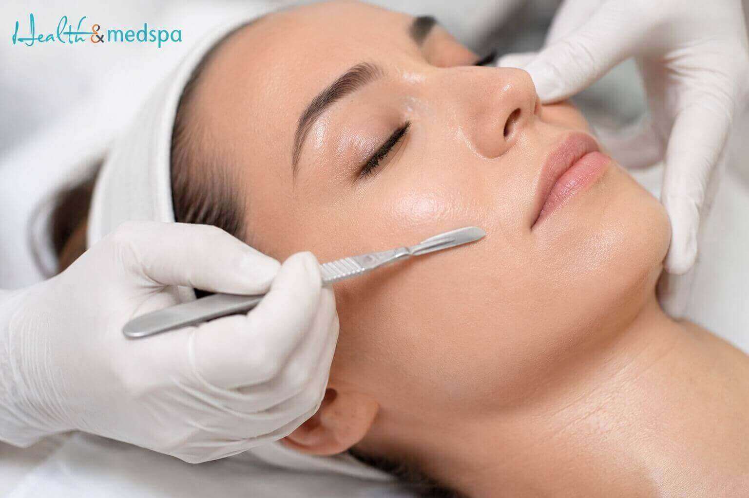 Close-up of glowing skin after a dermaplaning exfoliation facial treatment removing peach fuzz and dead skin