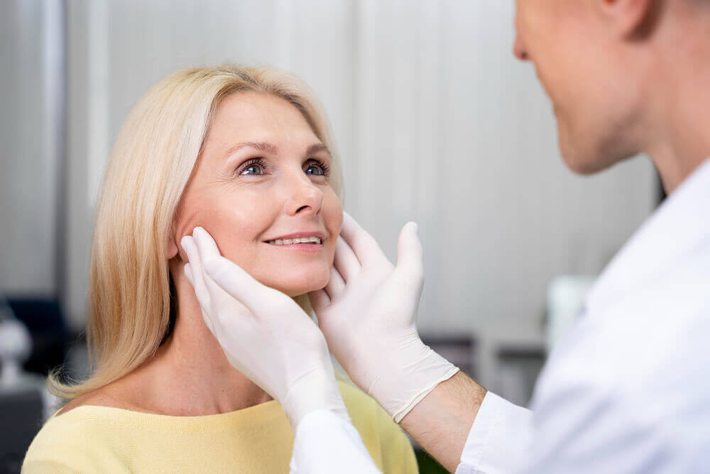 Licensed aesthetic practitioner observing before administering Botox injections near smile lines in a professional Tampa medspa.